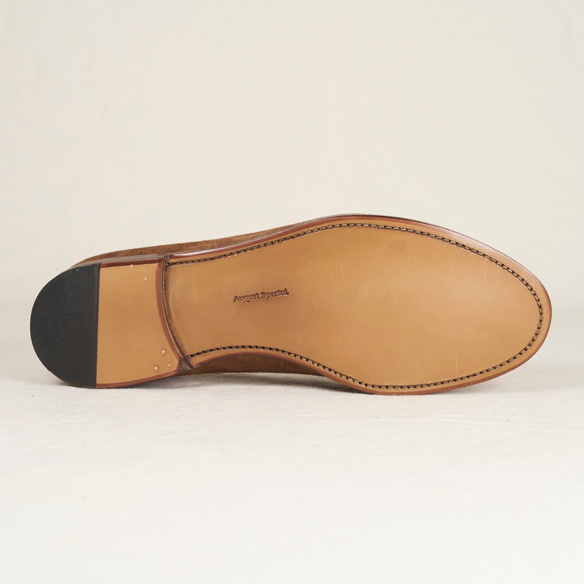 Sole view of August Special Augie Type-GS cubano calf suede Goodyear slip-on — hand-sewn welt, leather outsole.