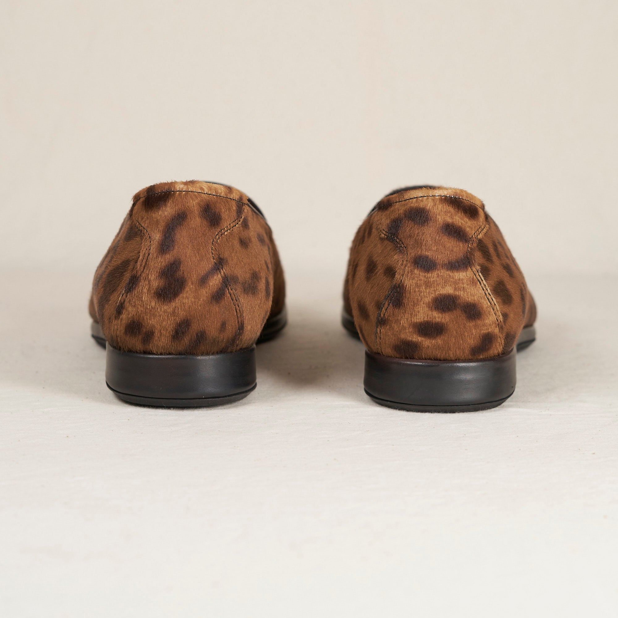 Augie Type-P Leopard Haircalf loafers – rear view of pair, brown haircalf with dark leopard print and black heel.