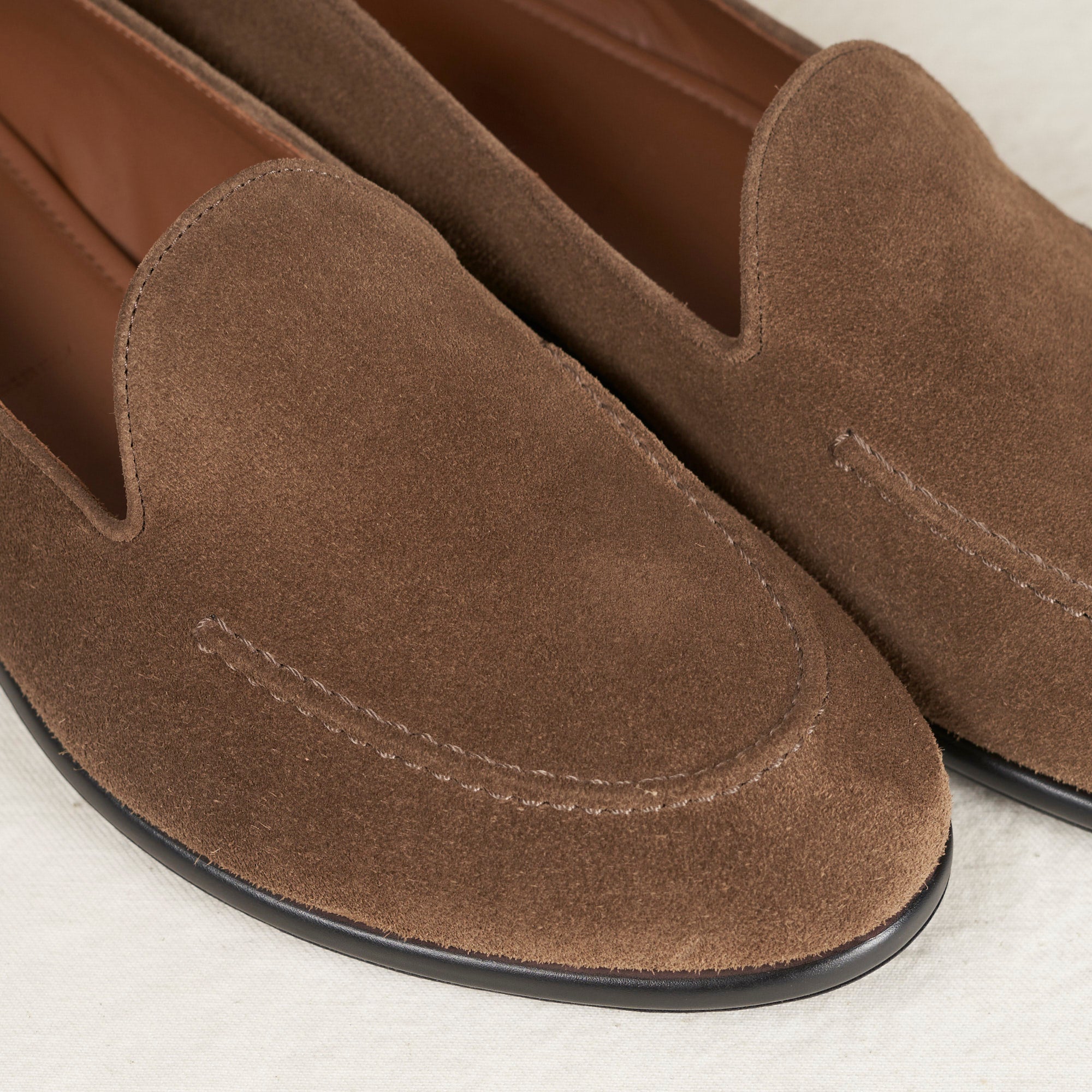 Close detail of tobacco suede and hand-sewn vamp stitch on the August Special Augie Type-S loafer.