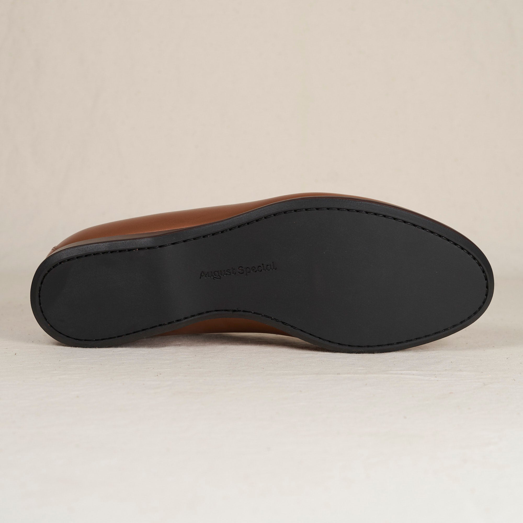 Close detail of cigar Maryam veg-tan calf and Blake-stitched outsole on the August Special Augie Type-P men's loafer.