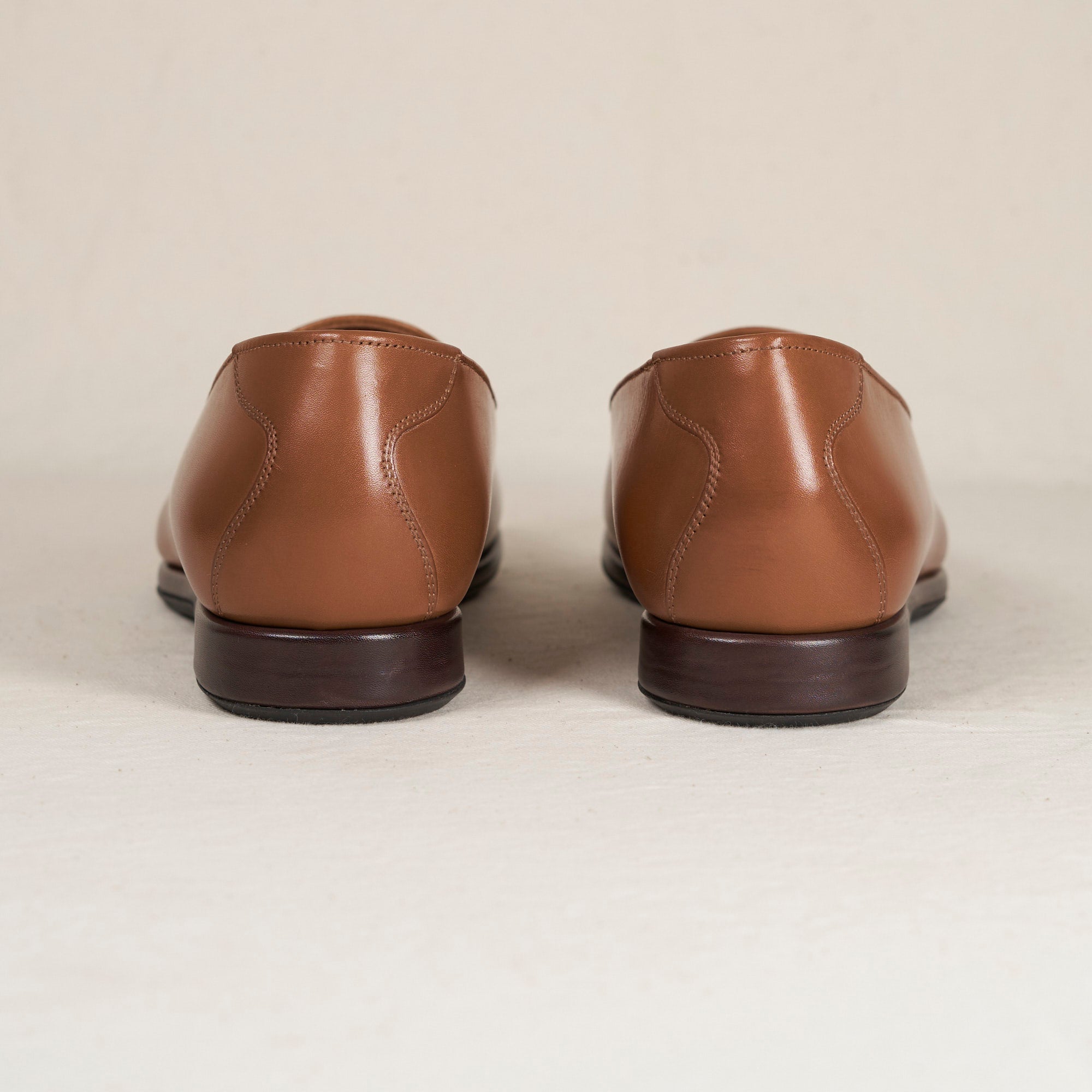 Back heel view of August Special Augie Type-P men's cigar veg-tan calf Blake loafer — cushioned insole, clean counter.