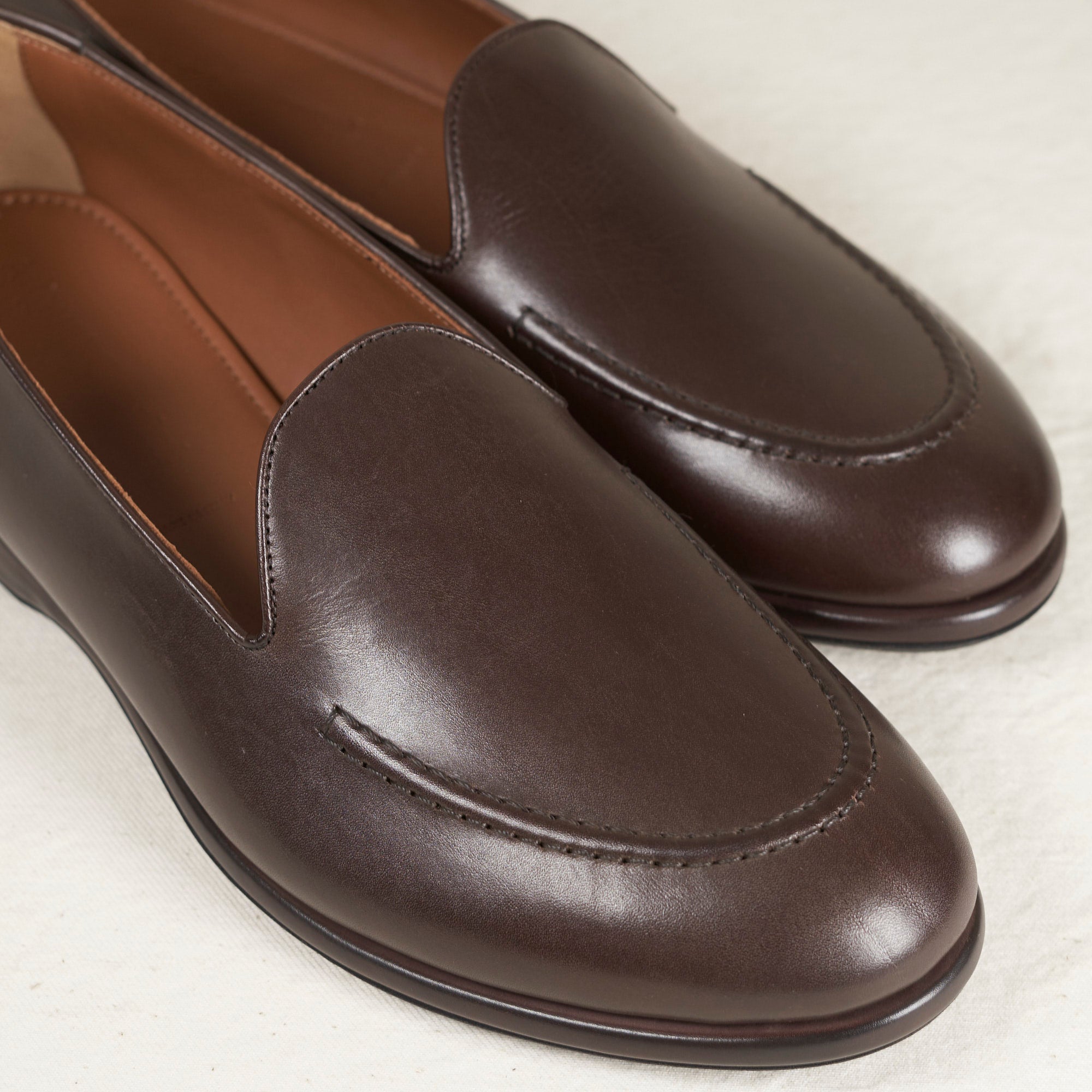 Close detail of espresso Maryam veg-tan calf and hand-sewn vamp stitch on the August Special Augie Type-S men's loafer.


