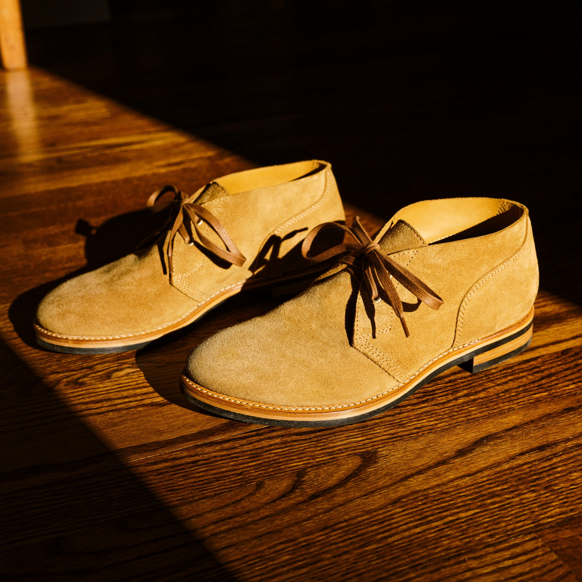 August Special aviator style Chukka boot with Goodyear welting and a Vibram outsole in full grain suede on oak floor