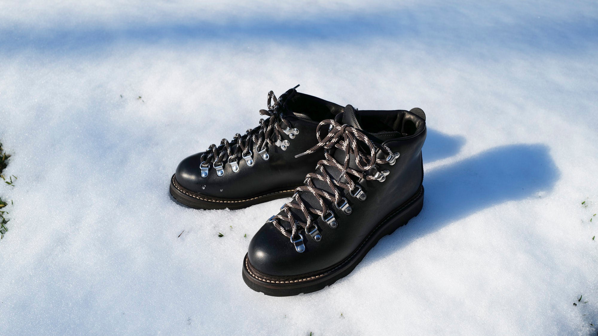 Black Rambler hiking boot sat on snow