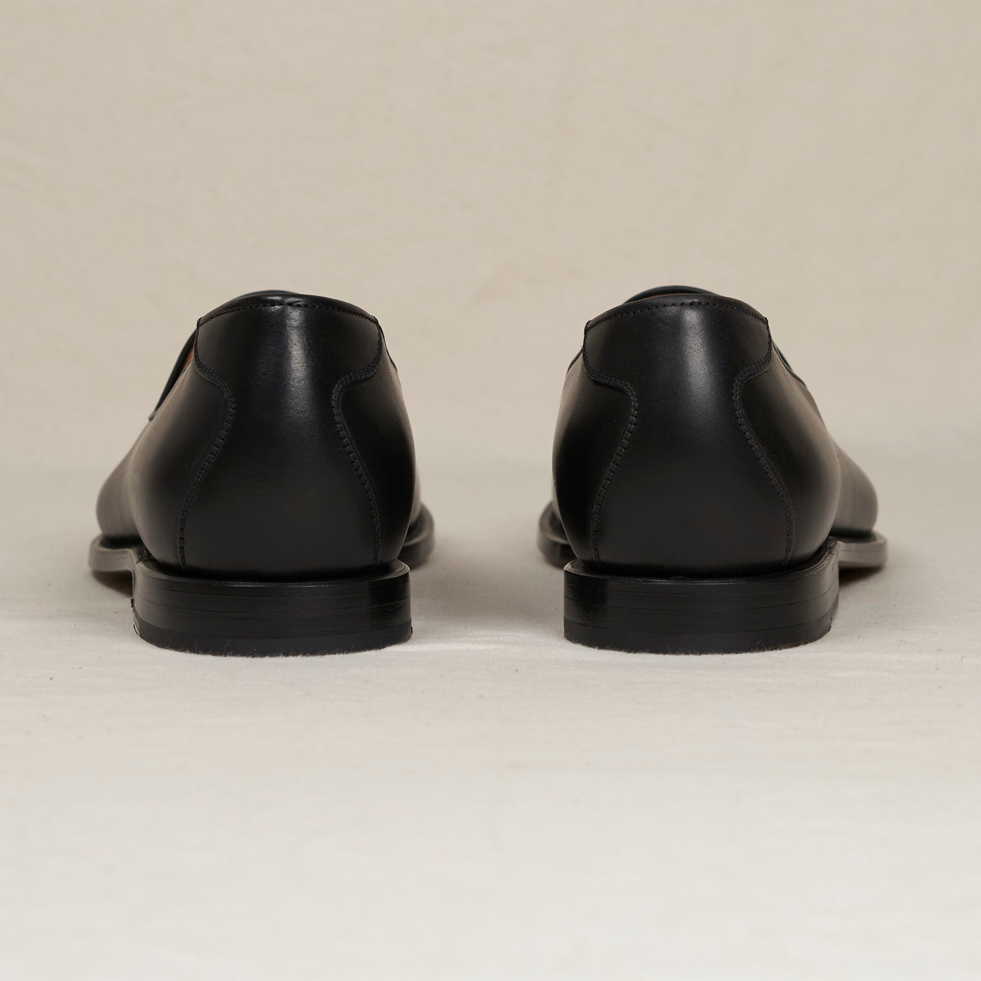 Back heel view of the August Special Augie Type-GP men's black veg-tan calf Goodyear loafer — clean counter, padded insole, Harry Last fit.