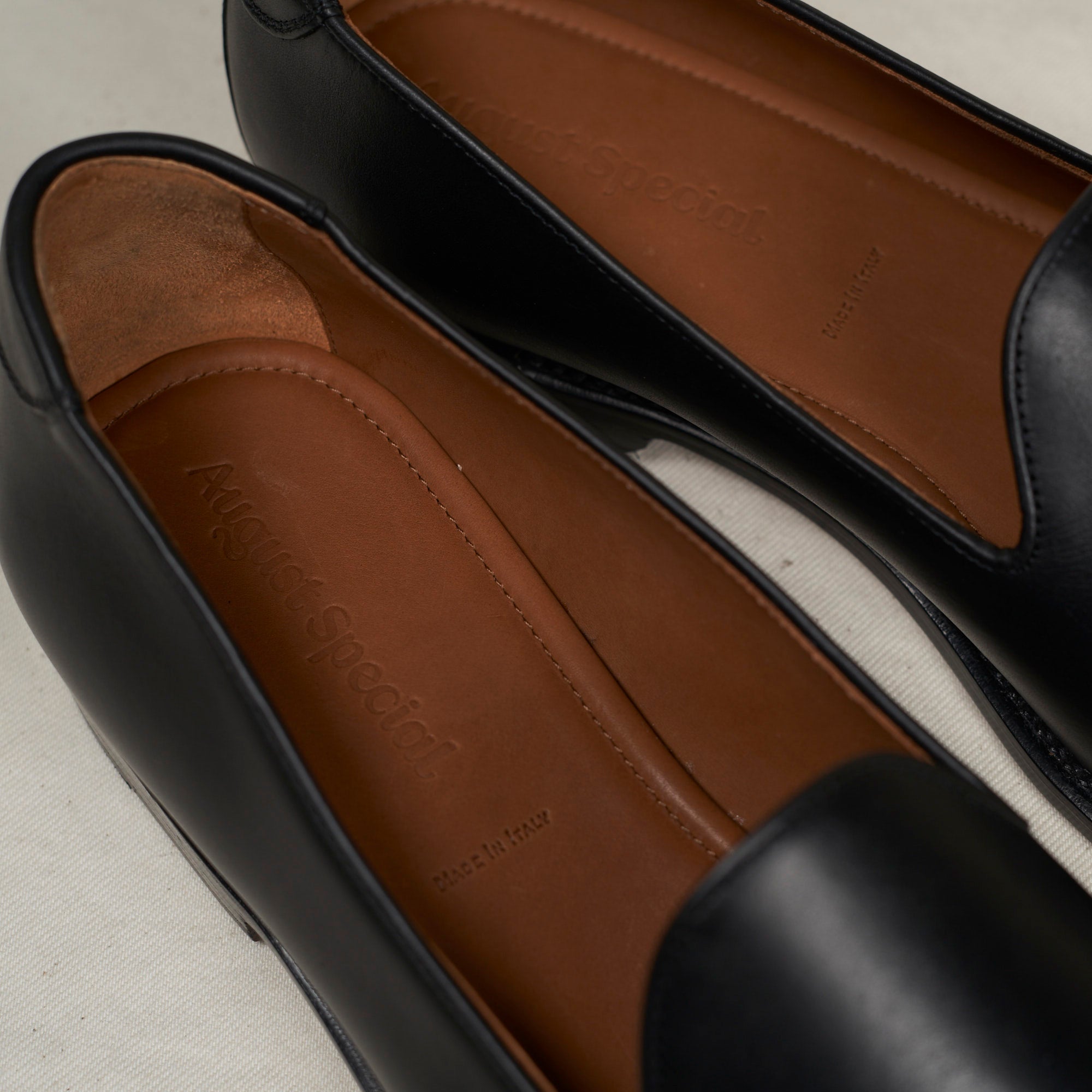 Close detail of the Goodyear welt stitch and black Maryam veg-tan calf upper on the August Special Augie Type-GP men's loafer.
