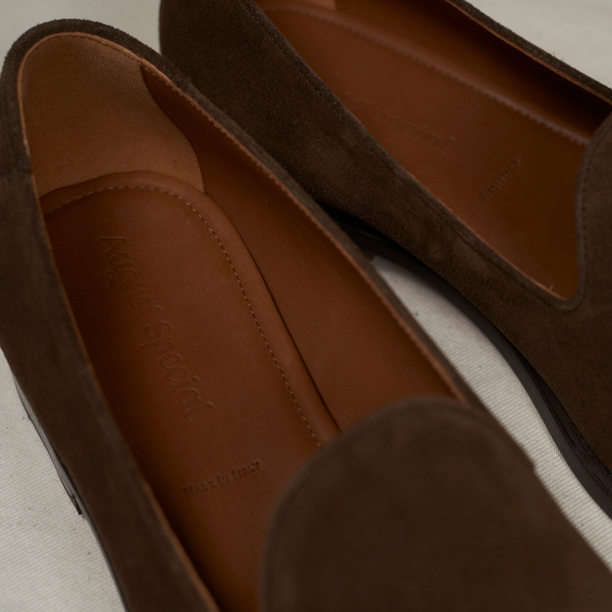 Close detail of brown Maryam veg-tan calf suede and Goodyear welt on the August Special Augie Type-GP men's loafer.