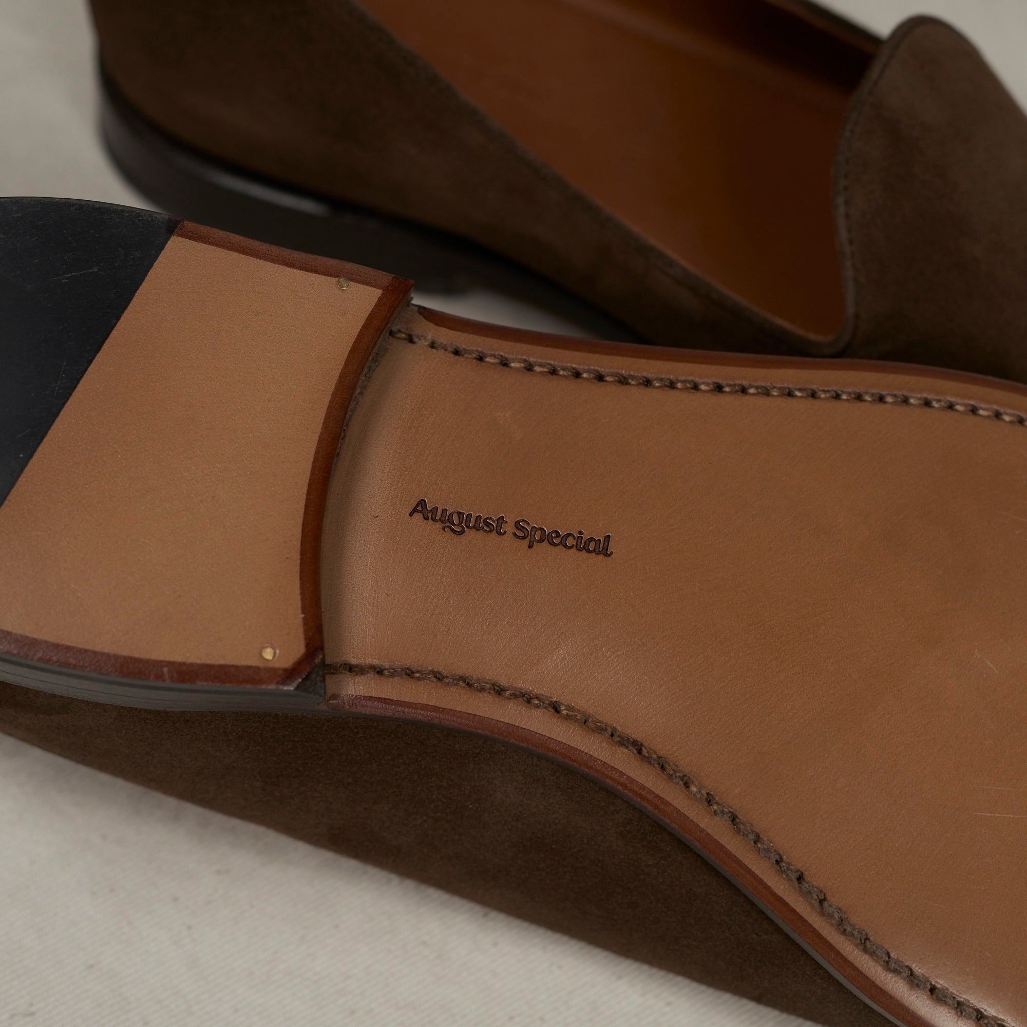 Sole view of August Special Augie Type-GP brown calf suede Goodyear loafer — hand-sewn welt and veg-tan leather outsole.