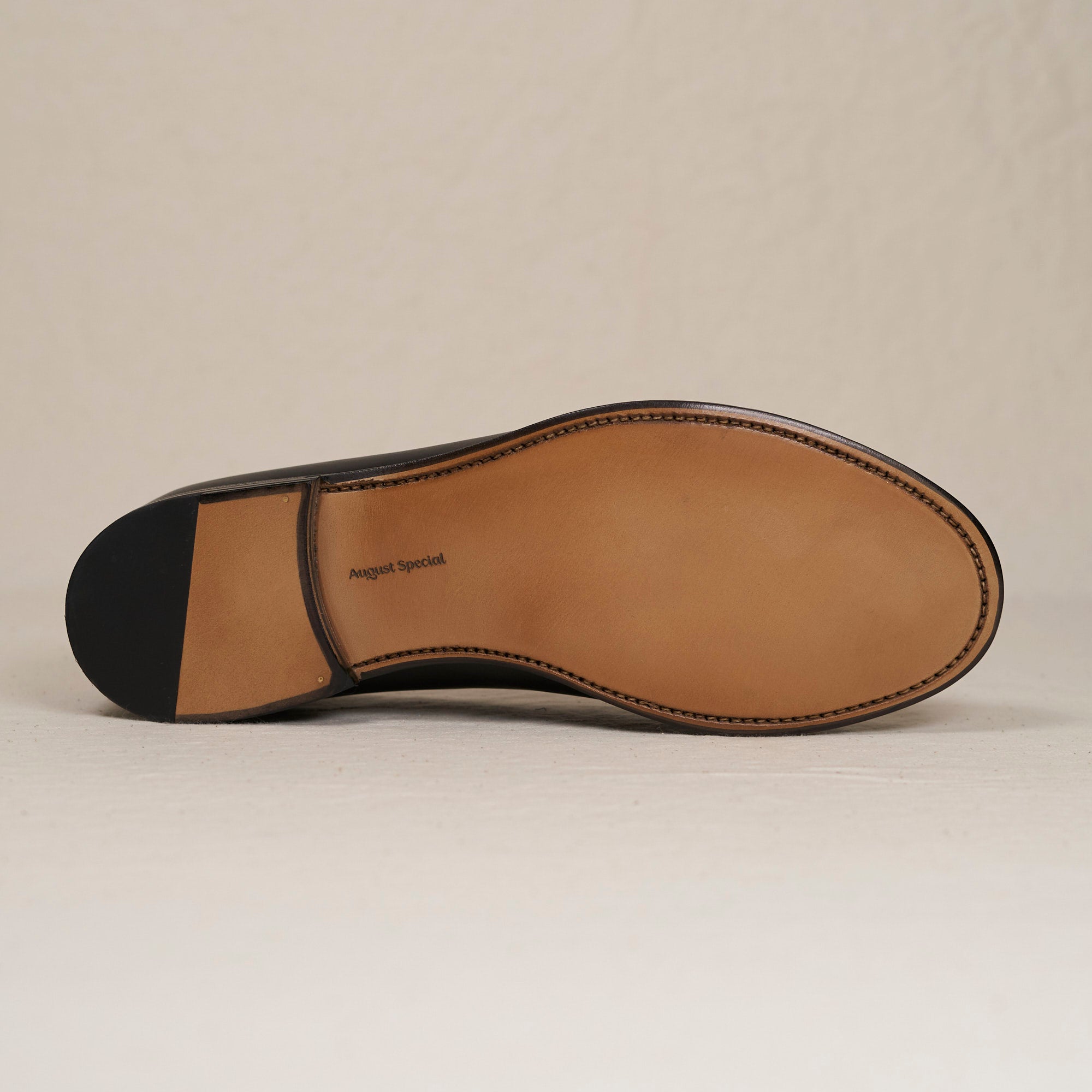 Sole view of August Special Augie Type-GS black veg-tan calf Goodyear slip-on — hand-sewn welt, leather outsole.