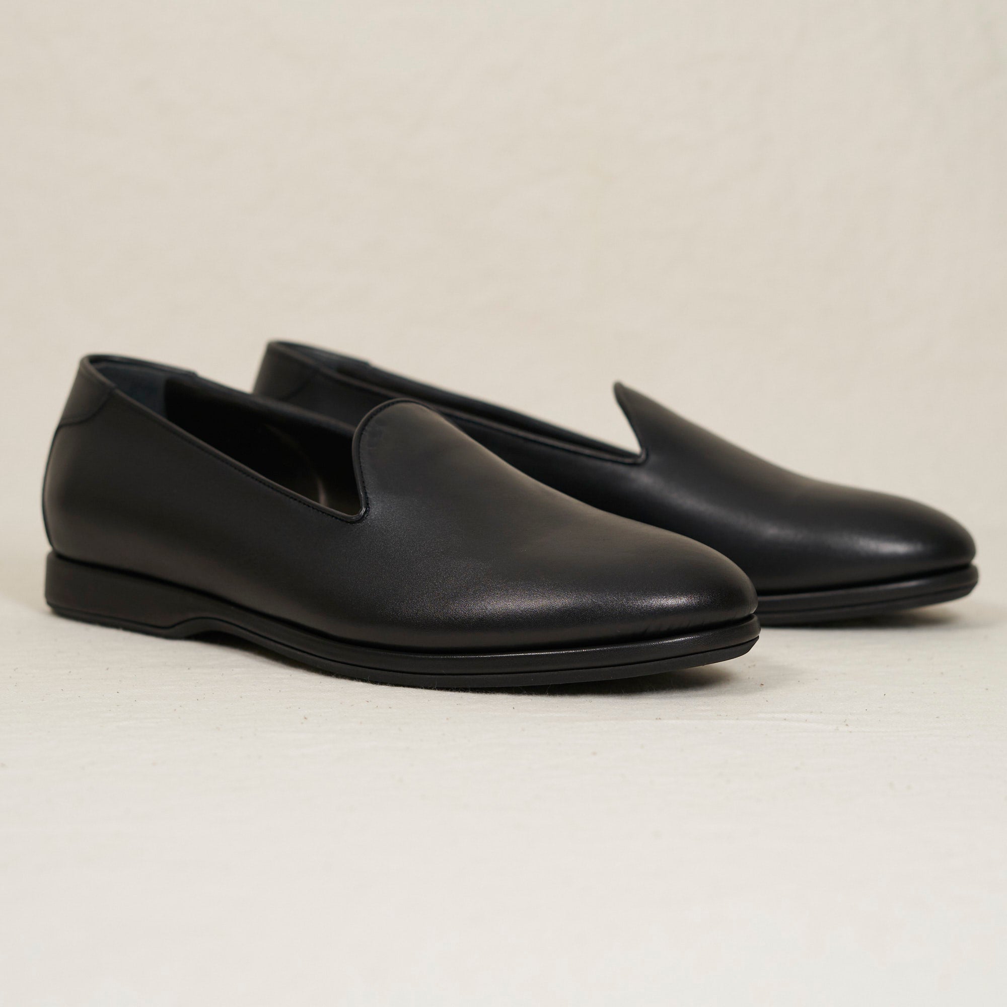 Angled view of August Special Augie Type-P black veg-tan calf Blake loafer — cushioned midsole, clean classic silhouette.
