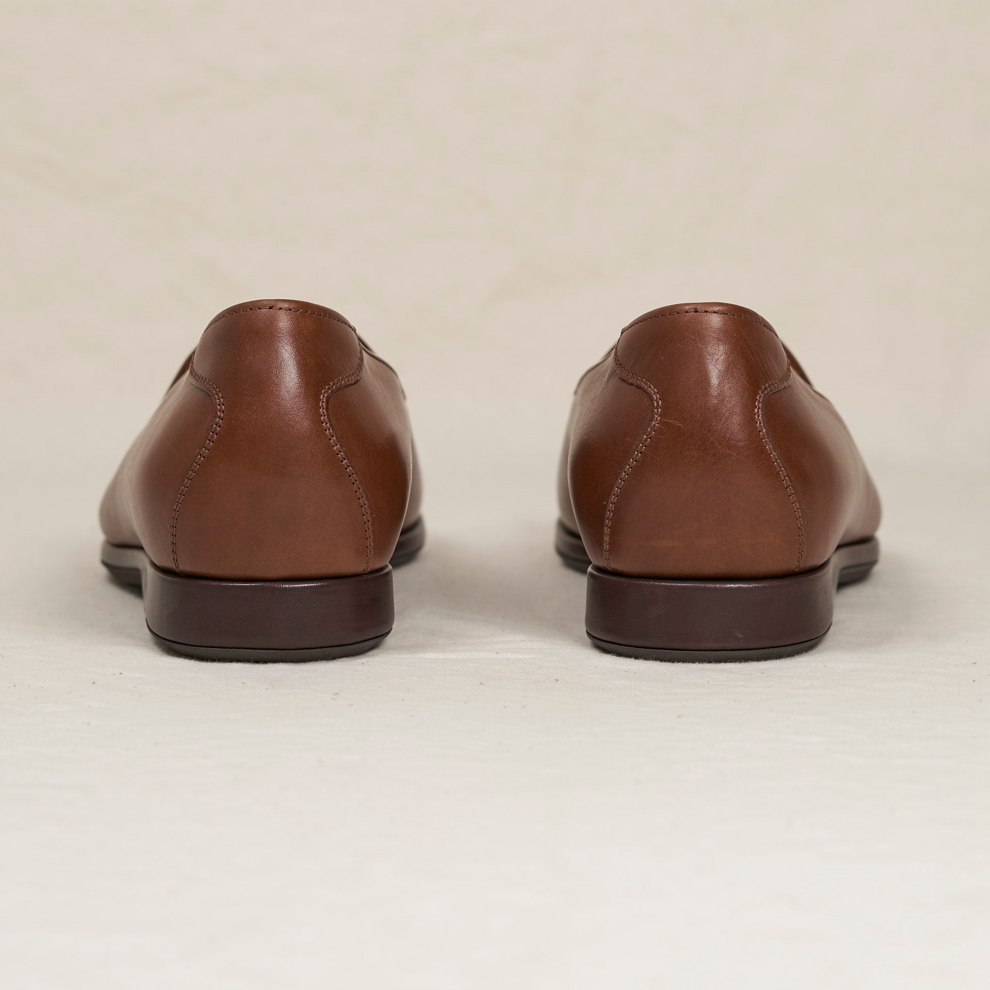 Back heel view of August Special Augie Type-P men's cigar veg-tan calf Blake loafer — cushioned insole, clean counter.