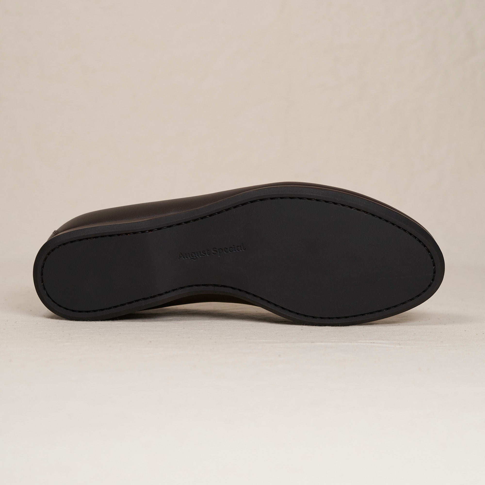 Sole view of August Special Augie Type-P espresso Maryam calf loafer — Blake-stitched rubber outsole and veg-tan welt.