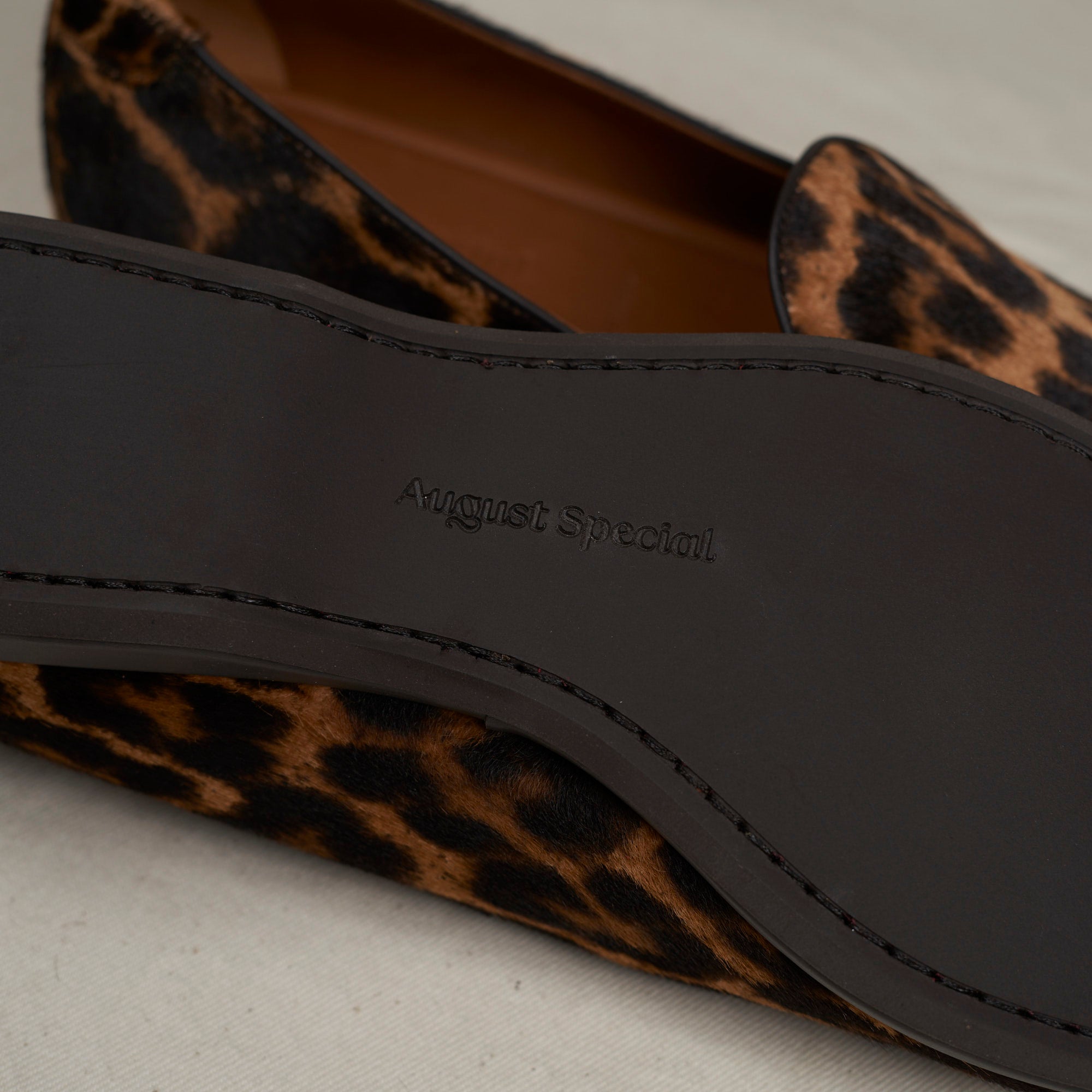 Sole view of August Special Augie Type-P light leopard haircalf — Blake-stitched rubber outsole and veg-tan welt.