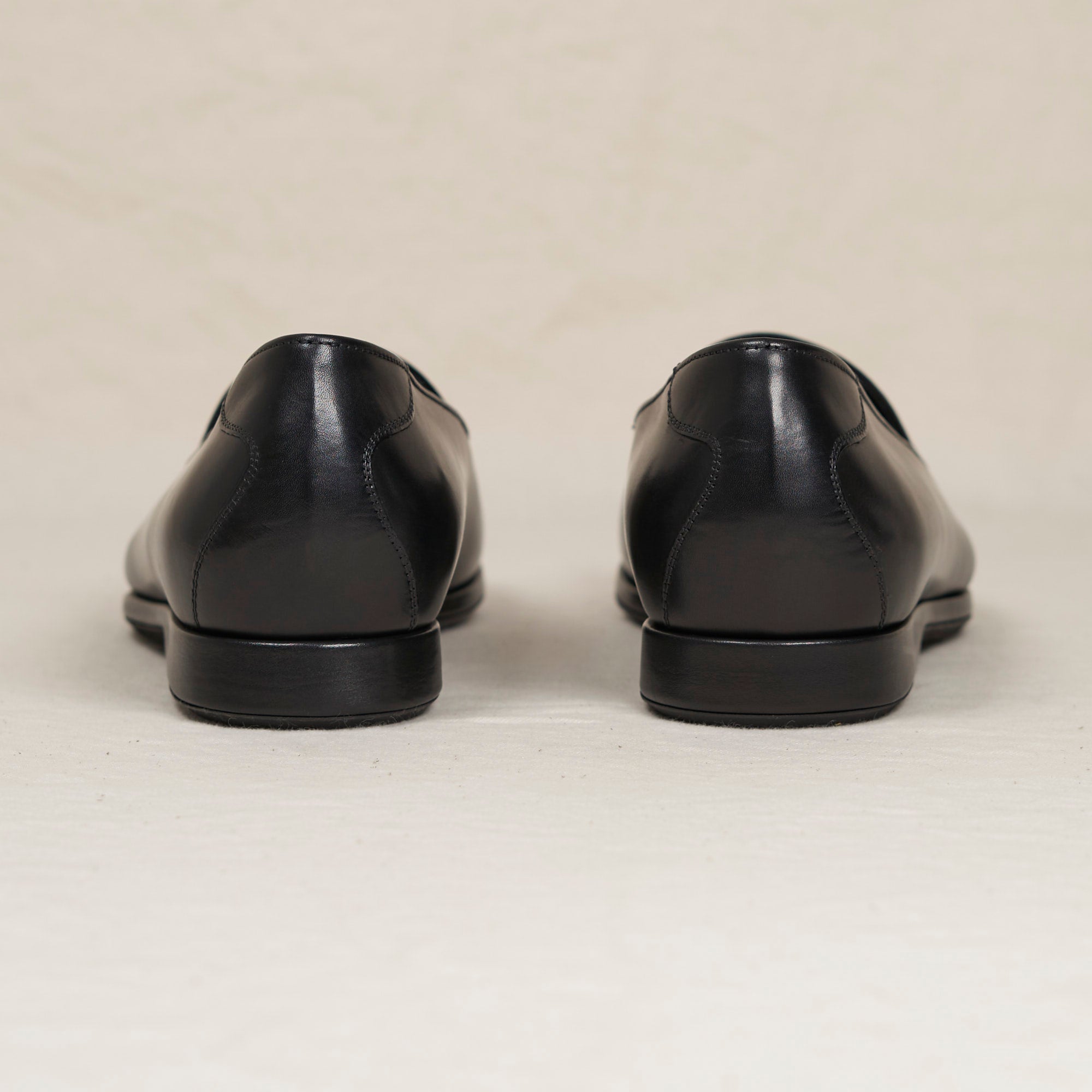 Back heel view of August Special Augie Type-S men's black veg-tan calf Blake loafer — cushioned insole, Harry Last fit.