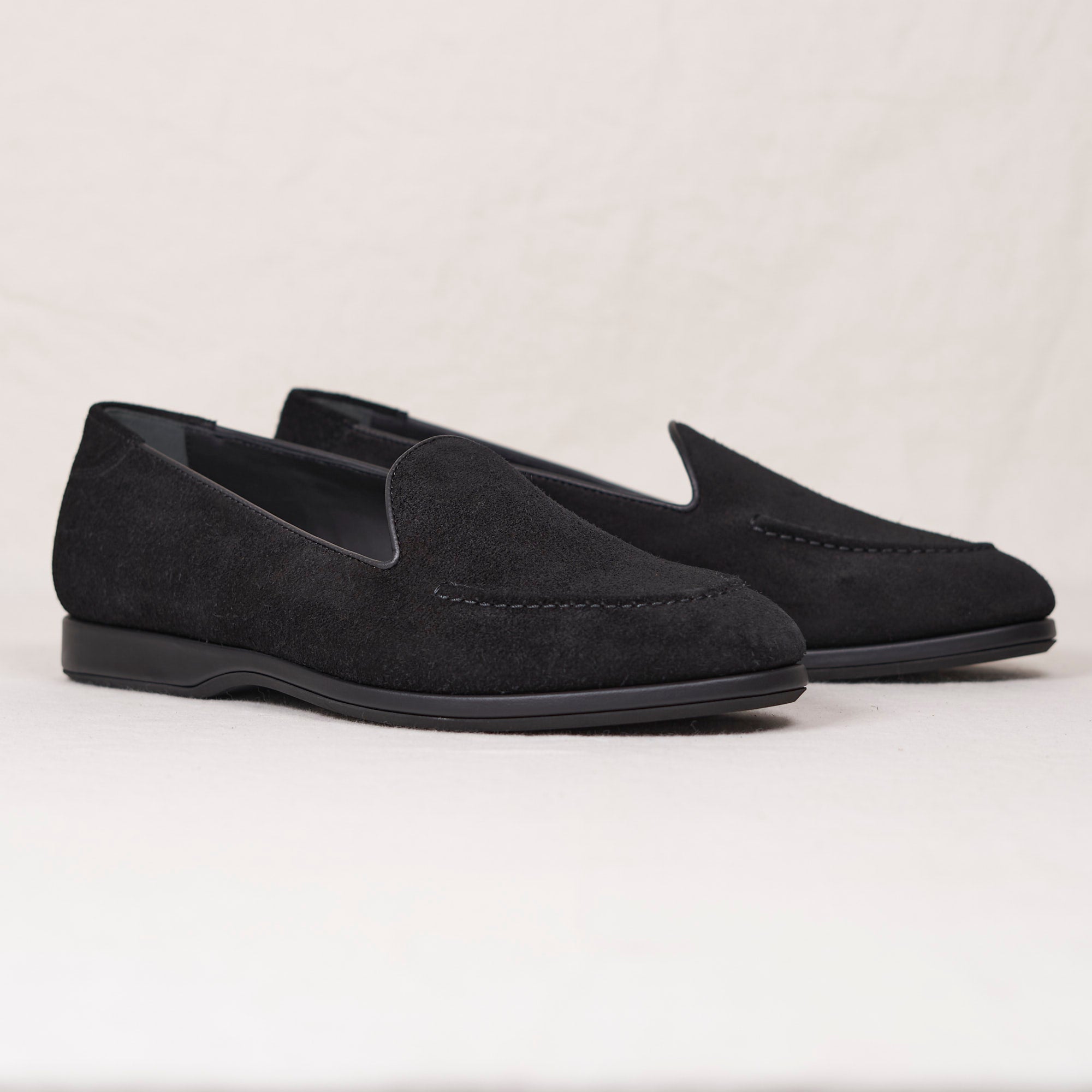 Angled view of August Special Augie Type-S black calf suede Blake loafer — hand-sewn vamp stitch, cushioned Harry Last.