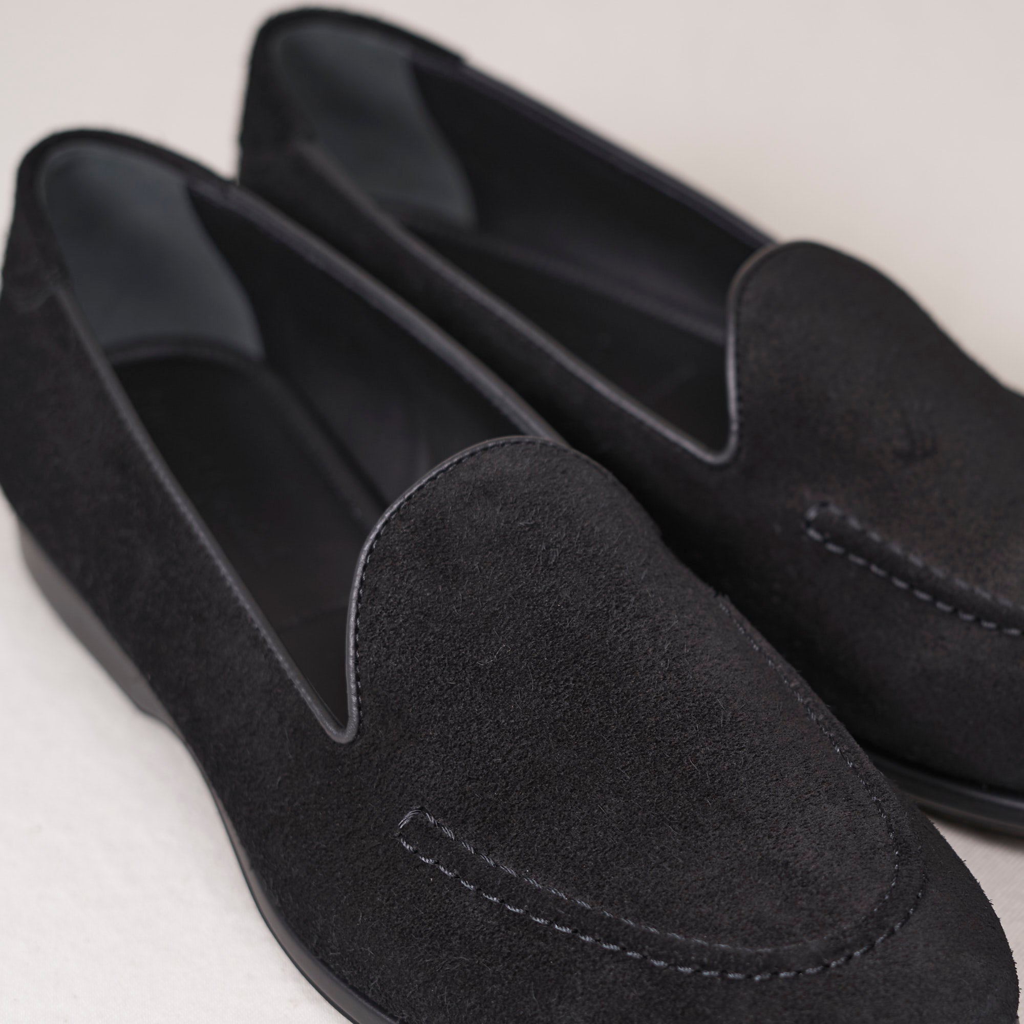 Close detail of black calf suede nap and hand-sewn vamp stitch on the August Special Augie Type-S men's Blake loafer.