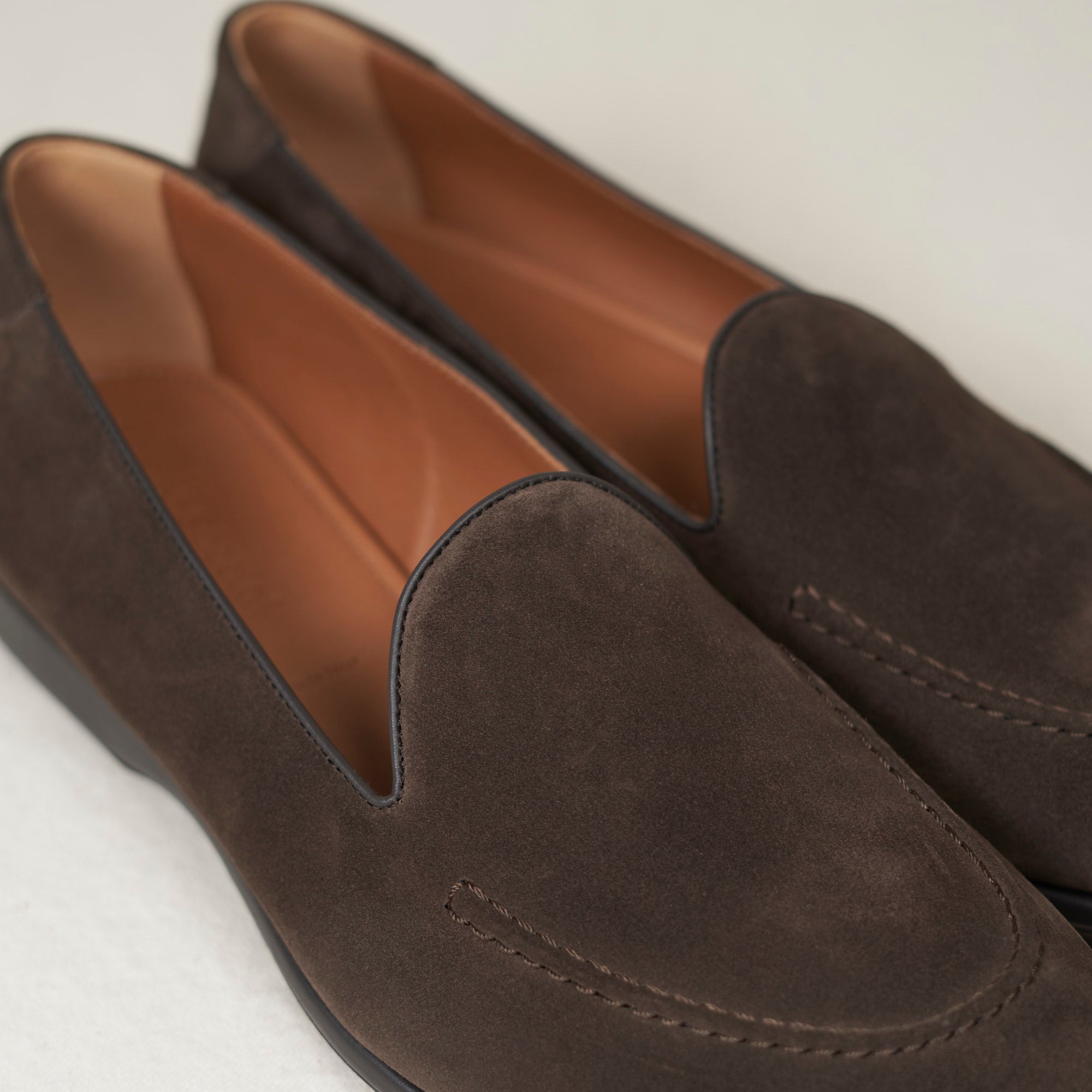 Close detail of earth calf suede nap and hand-sewn vamp stitch on the August Special Augie Type-S men's Blake loafer.