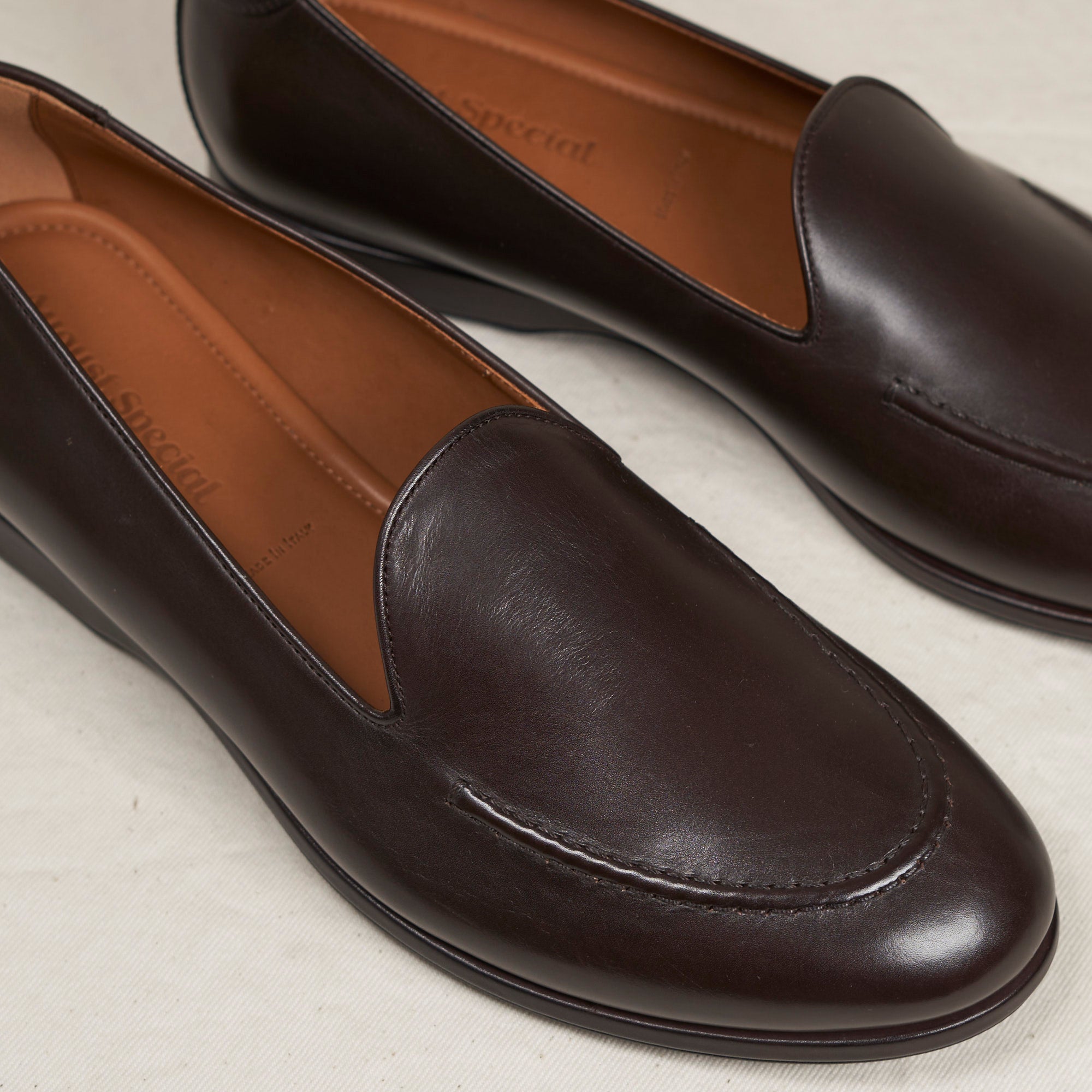 Close detail of espresso Maryam veg-tan calf and hand-sewn vamp stitch on the August Special Augie Type-S men's loafer.
