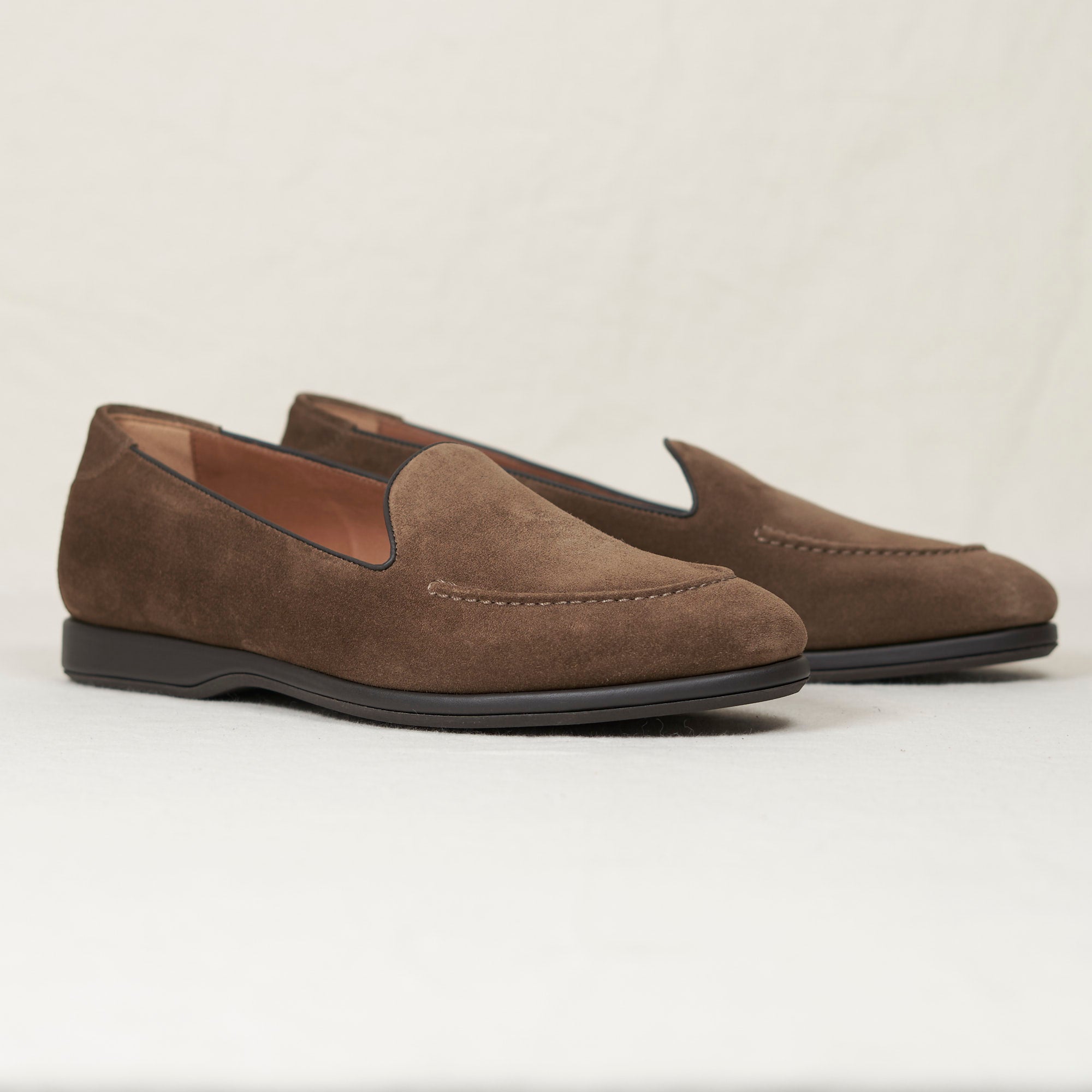 Angled view of August Special Augie Type-S walnut calf suede Blake loafer — hand-sewn vamp stitch, cushioned Harry Last.