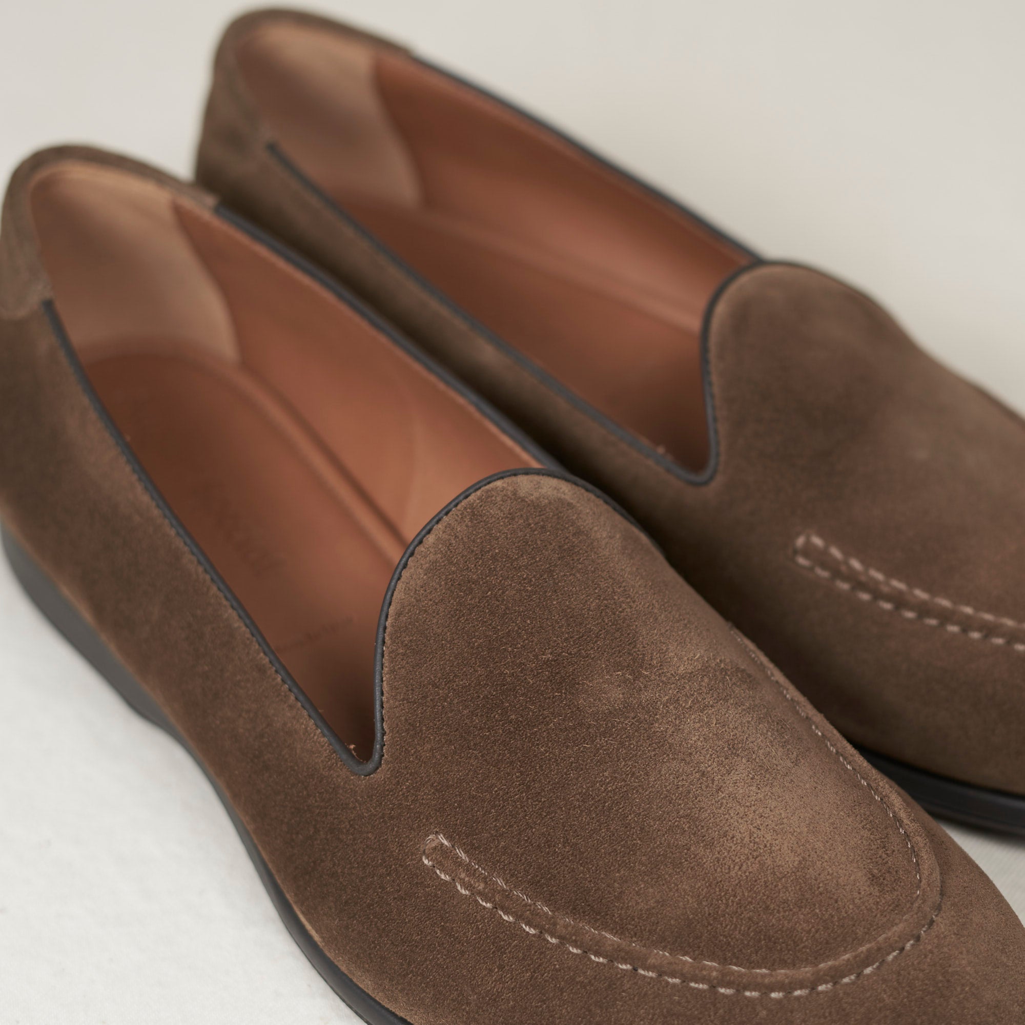 Close detail of walnut calf suede nap and hand-sewn vamp stitch on the August Special Augie Type-S men's Blake loafer.