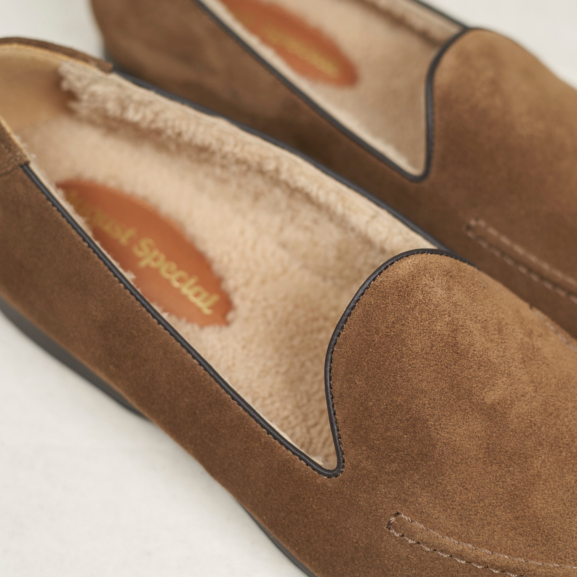 Close detail of walnut calf suede and shearling lining on the August Special Augie Type-SH men's Blake loafer.