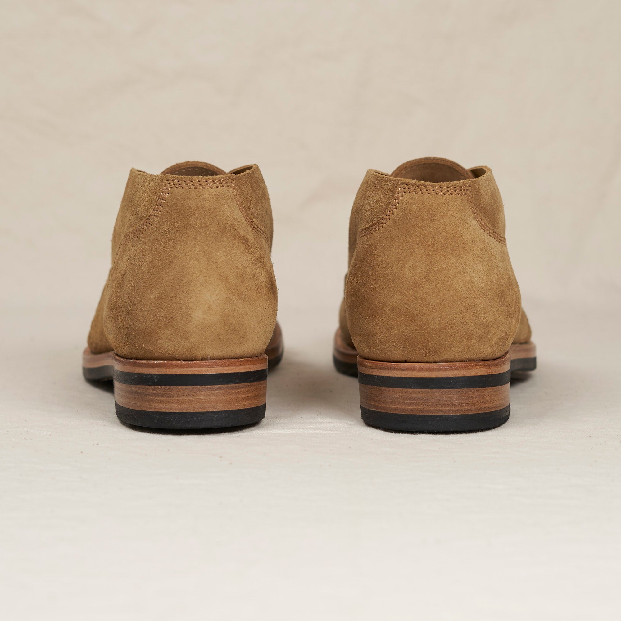 Back heel view of August Special Aviator men's marraca suede Goodyear chukka — double-layer counter, Vibram sole.