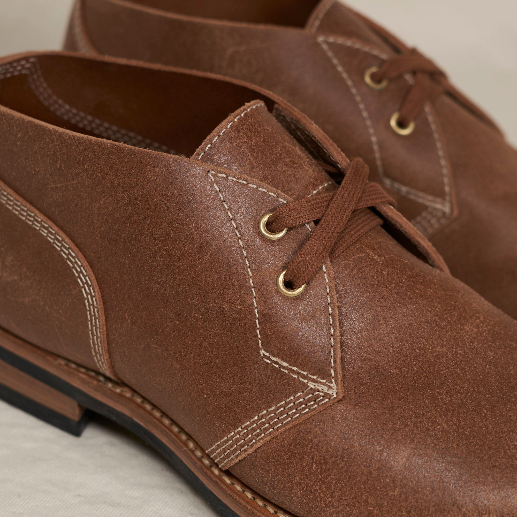 Close detail of roughout suede and Goodyear welt construction on the August Special Aviator men's chukka boot.