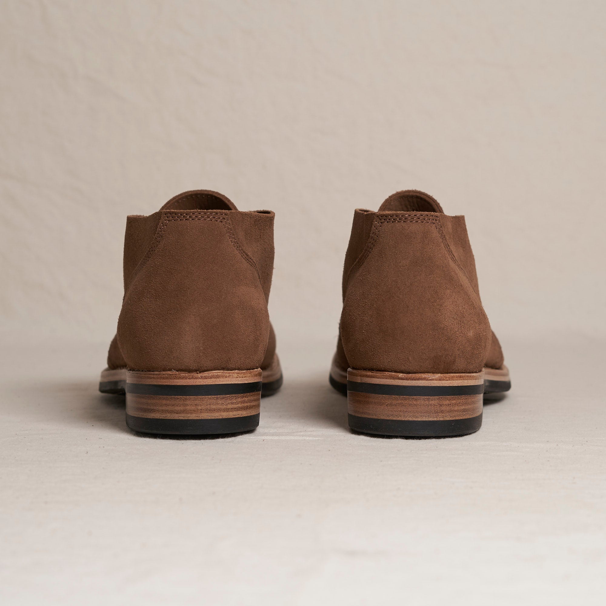 Back heel view of August Special Aviator men's snuff suede Goodyear chukka — double-layer counter, Vibram outsole.