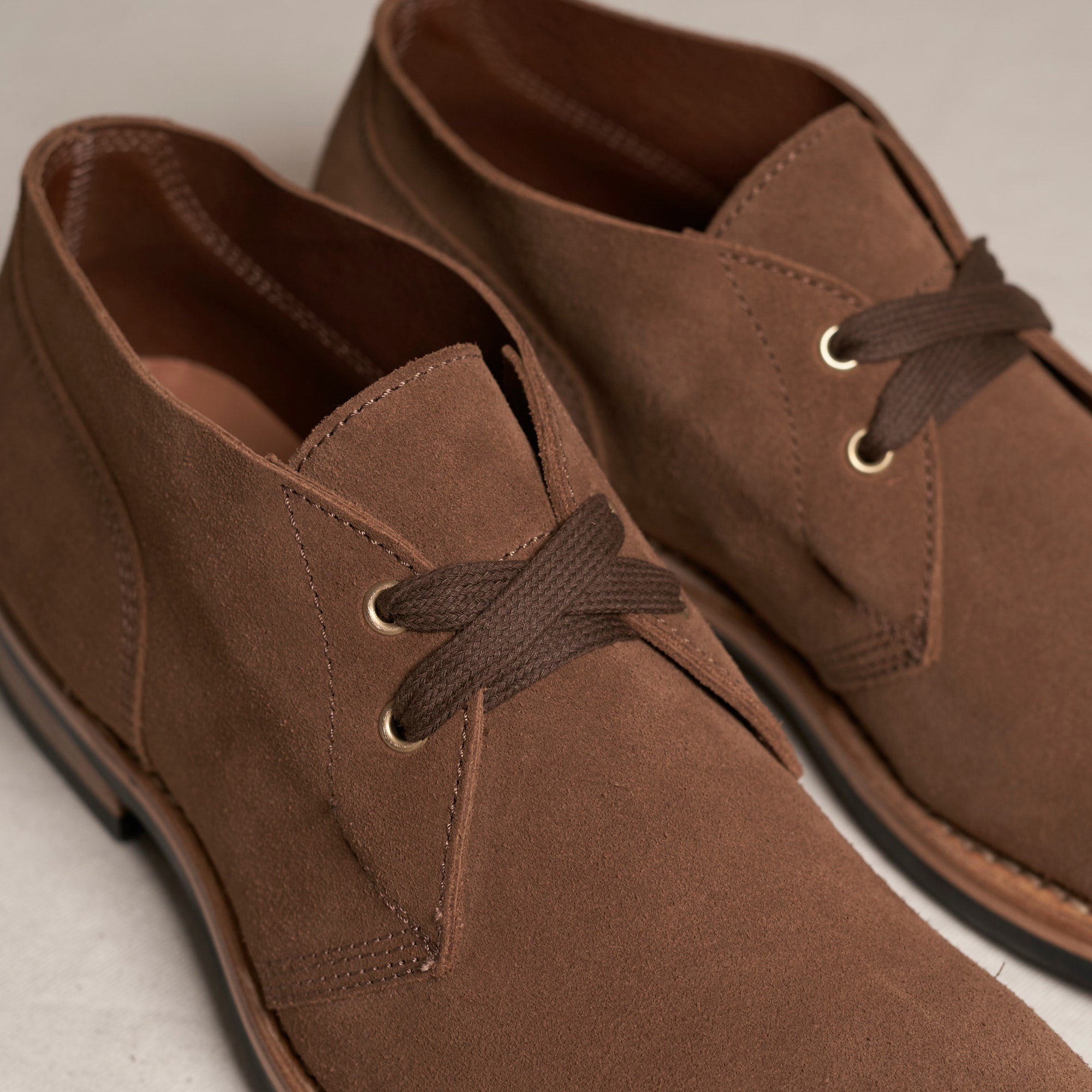 Close detail of snuff Maryam veg-tan suede and Goodyear welt on the August Special Aviator men's chukka boot.