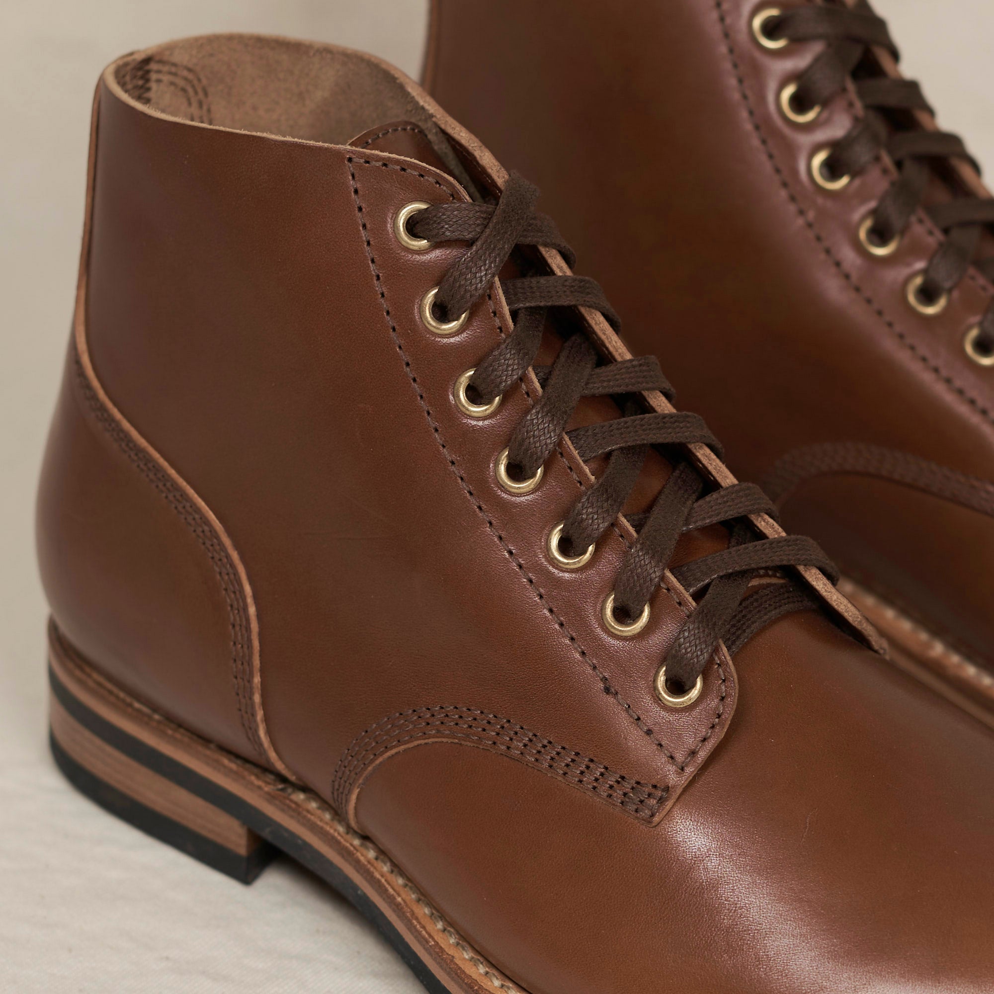 Close detail of full-grain vacchetta horsehide and Goodyear welt on the August Special Belliver men's field boot. Awarded Best Boot 2026 by NYT Wirecutter.