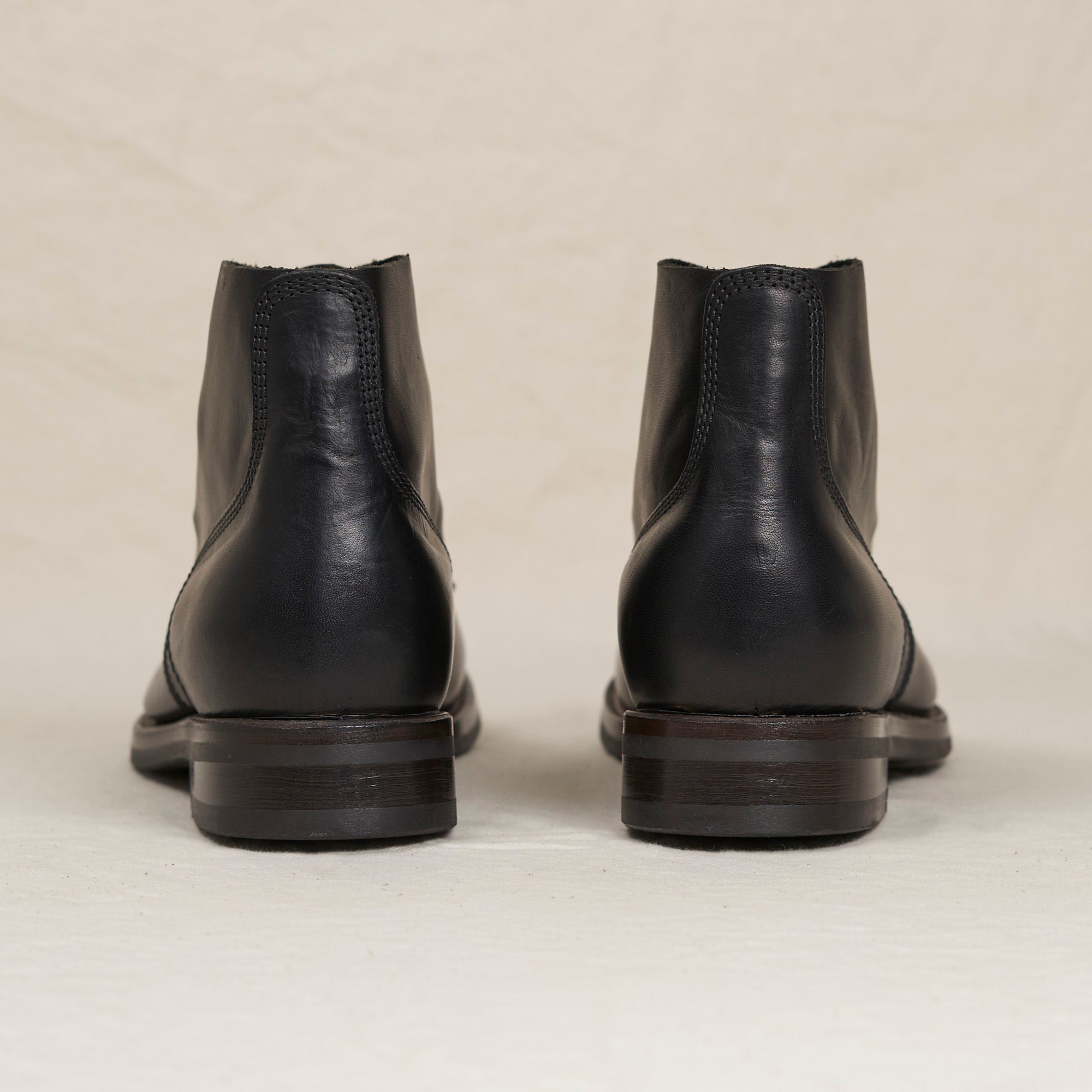 Back heel view of the black Belliver boot highlighting the double-layer counter and durable Vibram rubber outsole.