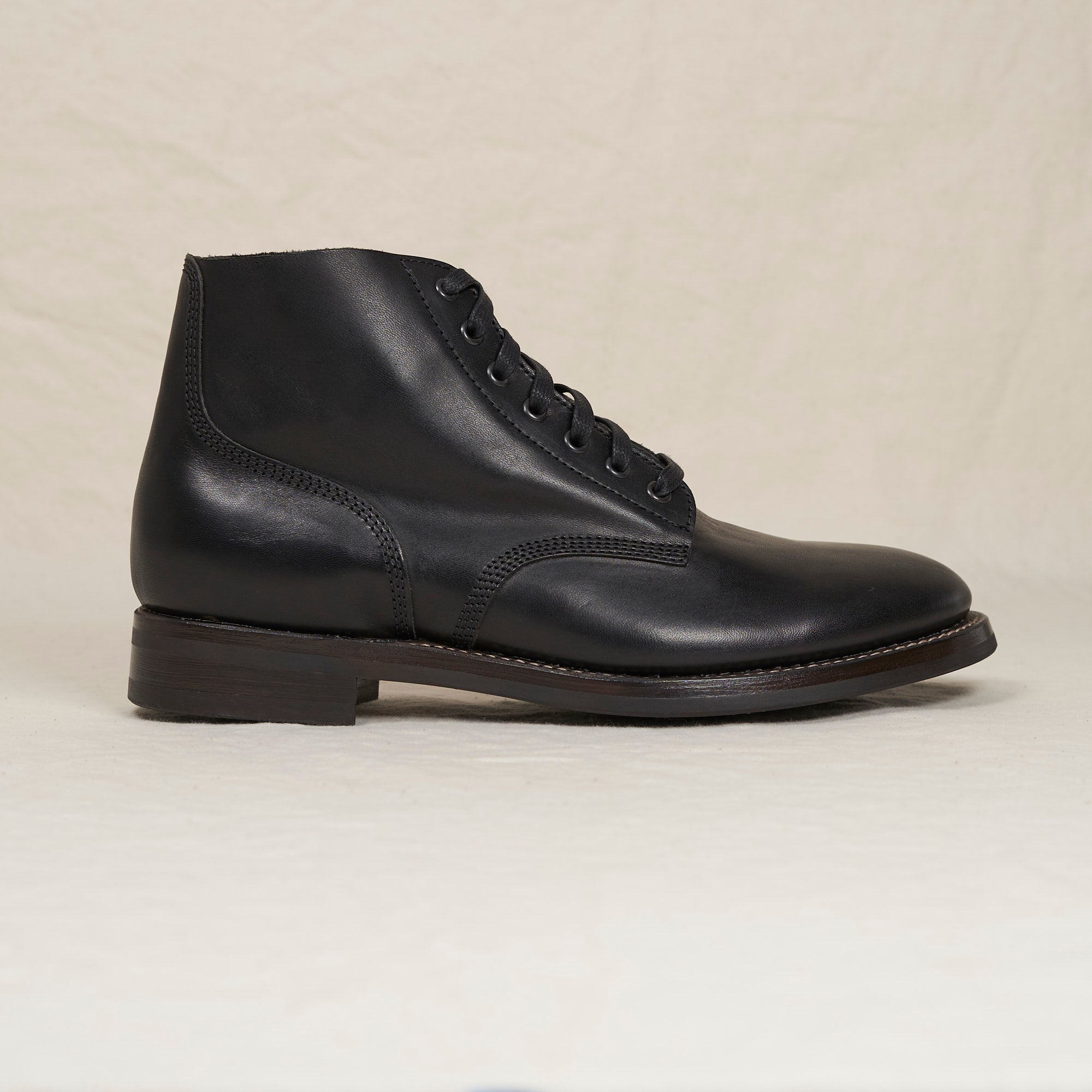 Side profile of the black Belliver, a 1930s-inspired US Navy field boot in Conceria Maryam smooth vacchetta horsehide.