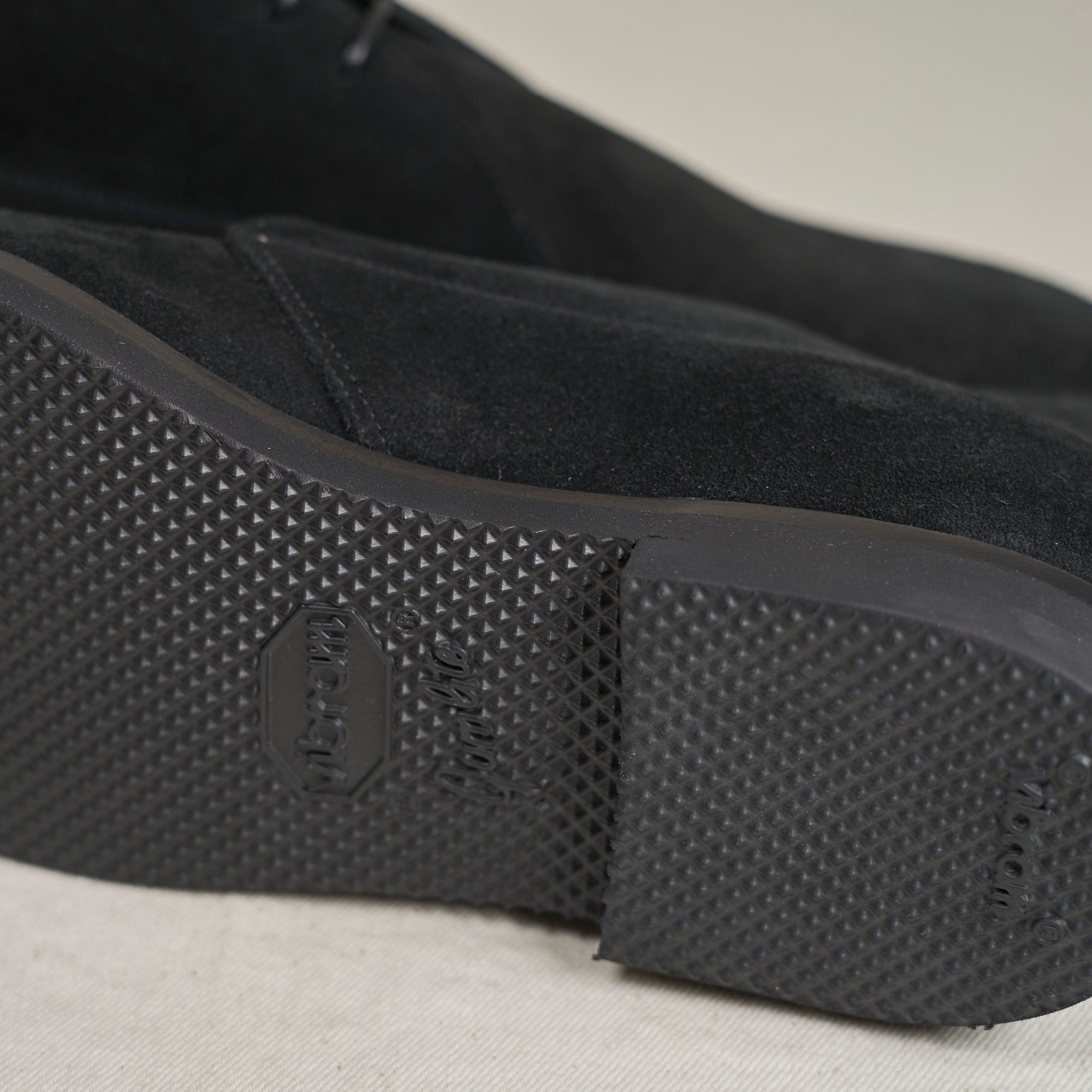 Sole view of August Special Voyager men's black suede chukka — slim Voyager Last, classic American silhouette.