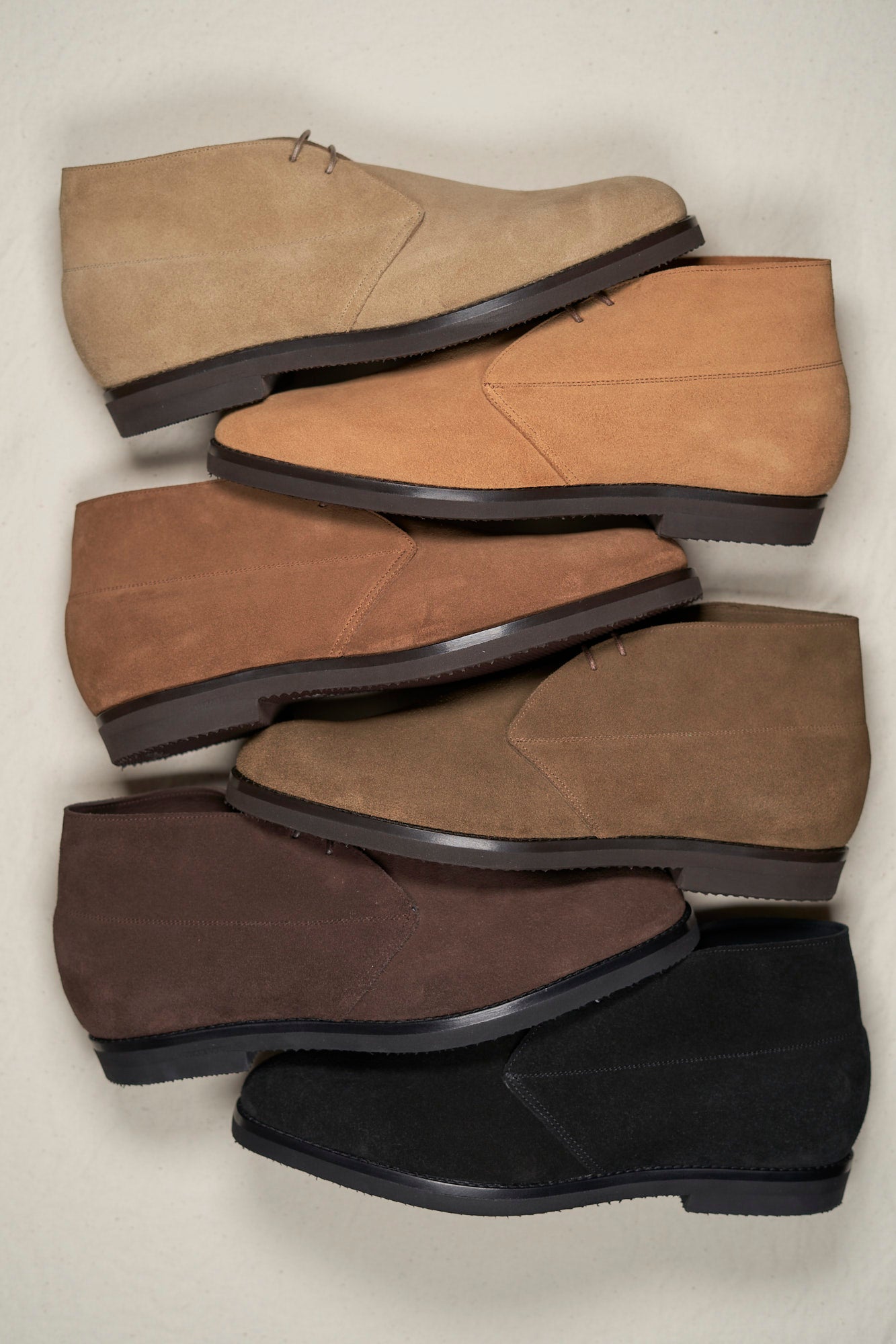 Three pairs of August Special Voyager men's suede chukka boots in dark colorways — classic American style.