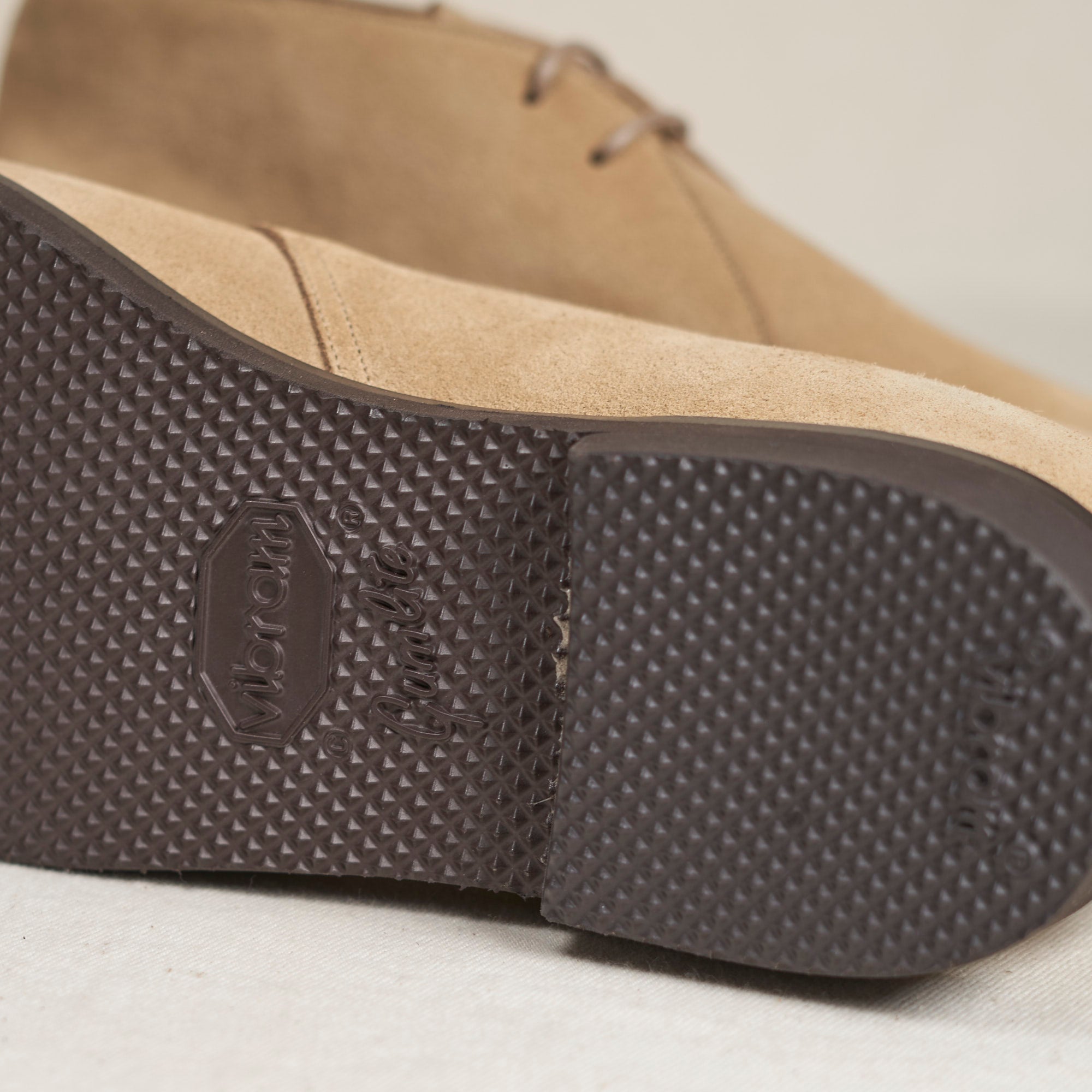 Sole view of August Special Voyager men's sand suede chukka — Vibram Gumlite outsole, Voyager Last fit, clasic American style.