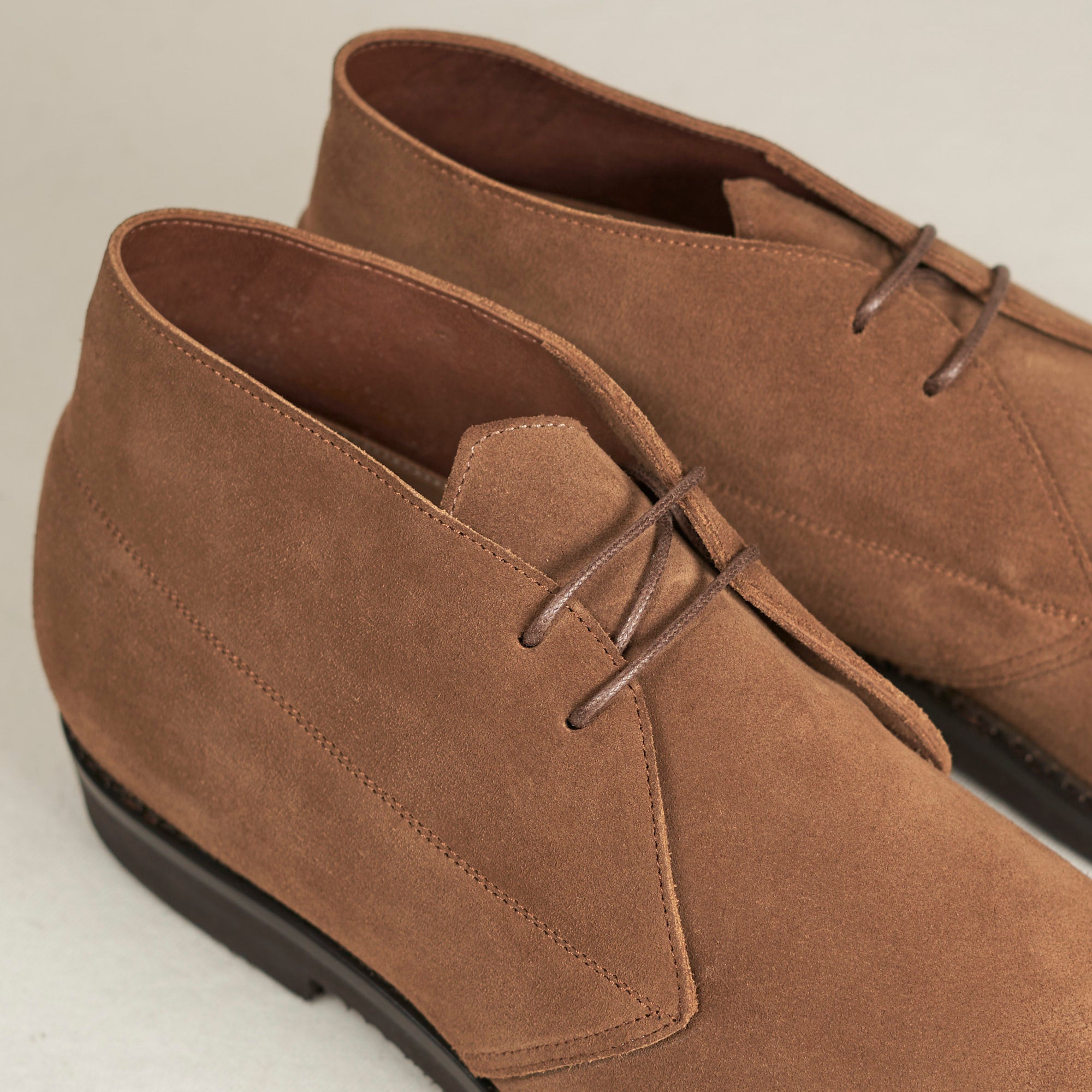 Close detail of tobacco full-grain suede and Blake stitch on the August Special Voyager men's chukka boot.