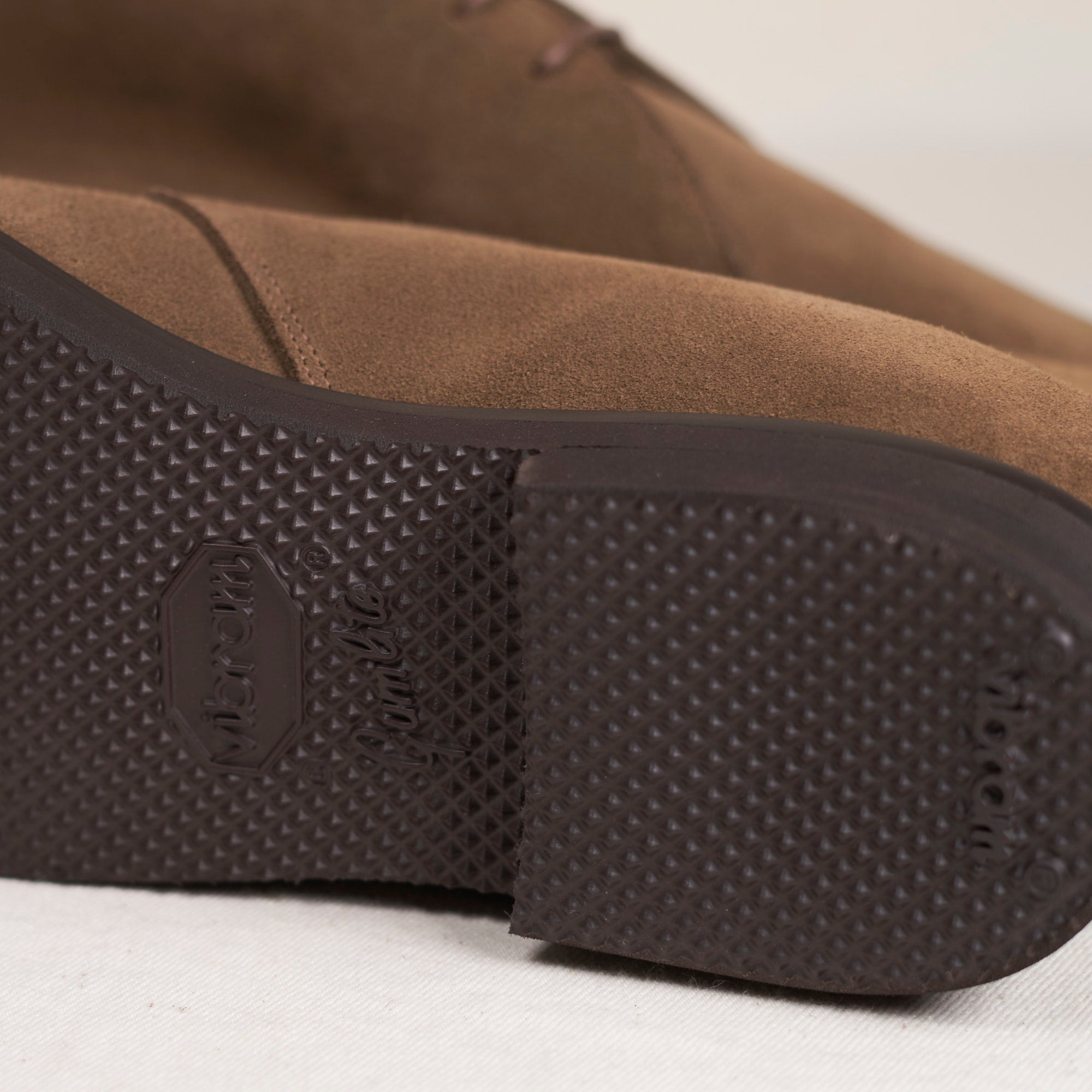 Sole view of August Special Voyager men's tobacco suede chukka — Vibram Gumlite outsole, Voyager Last fit. Classic American style.